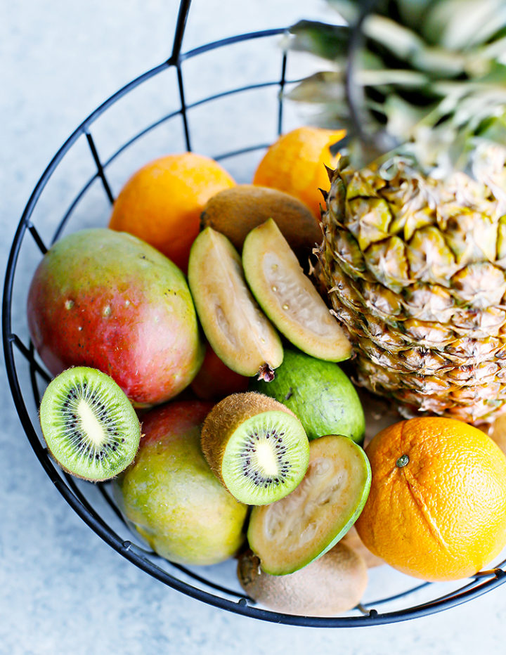 a photo of a metal basket of tropical fruits for a tropical fruit salad recipe