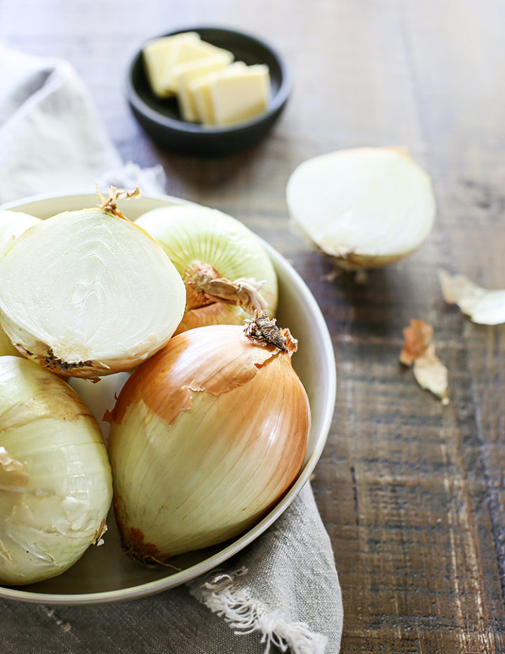 photo of a bowl of onions on a wooden table