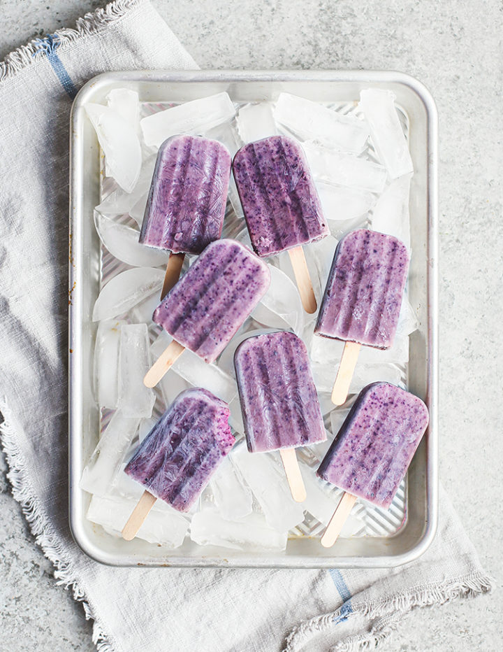 tray with ice and frozen blueberry popsicles