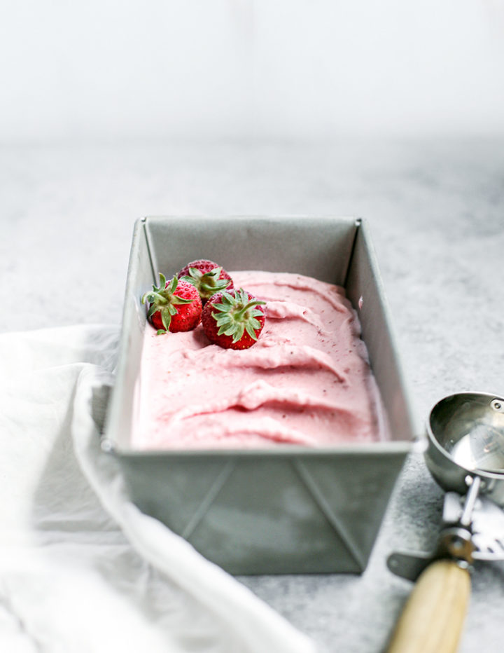 photo of strawberry gelato in a container with an ice cream scoop