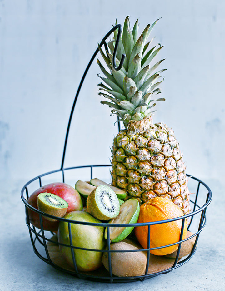 a photo of different types of tropical fruit in a basket