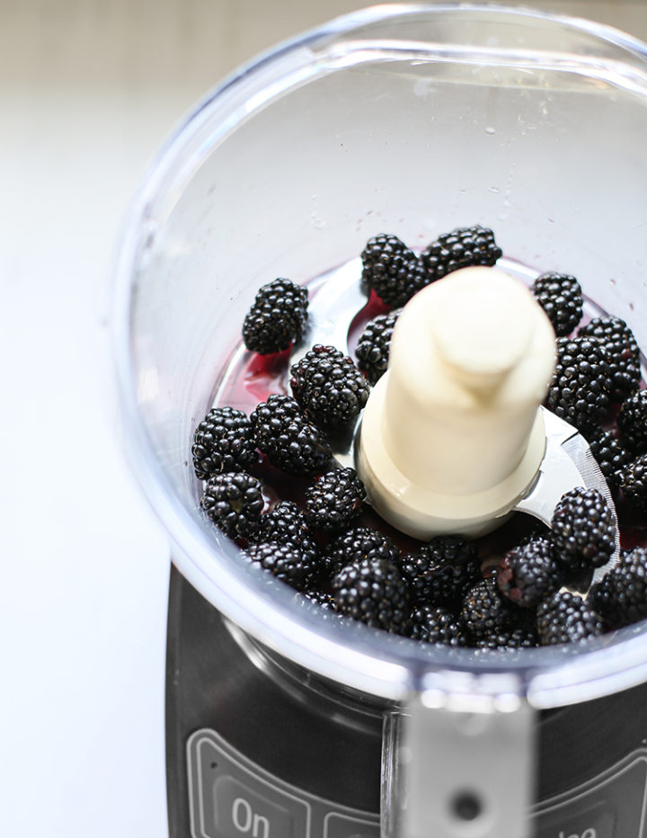 photo of blackberries in a food processor to make blackberry buttercream frosting