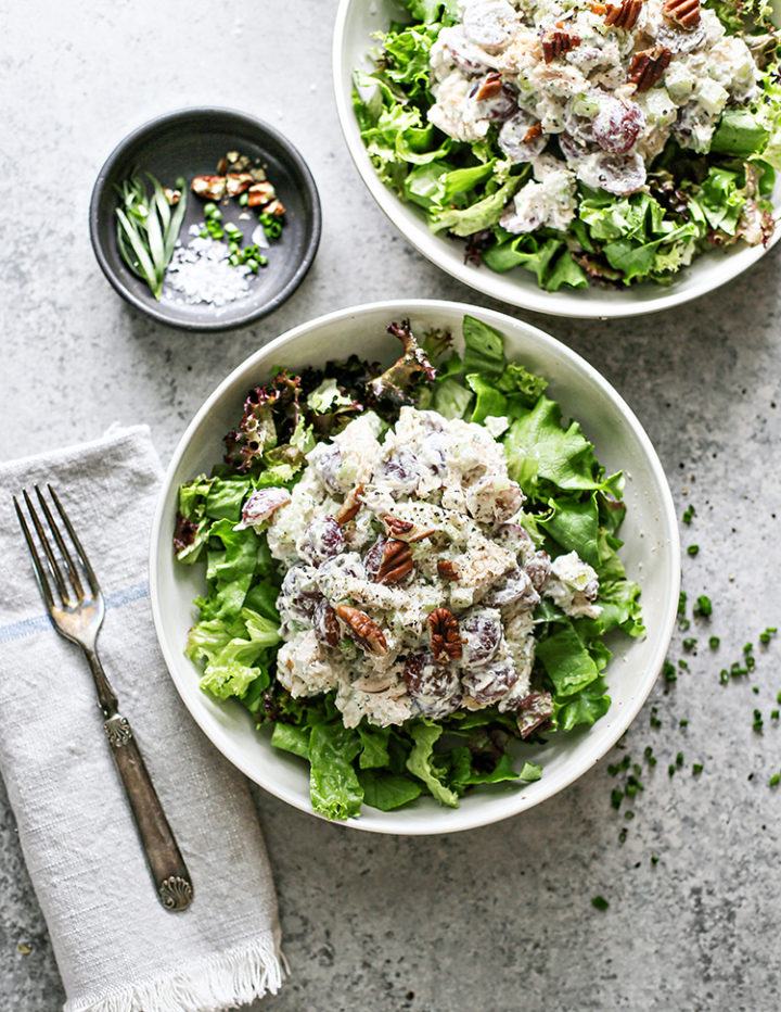 overhead photo of a table set with two servings of greens and tarragon chicken salad