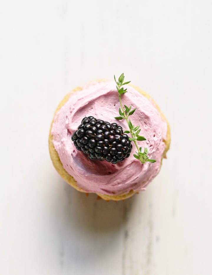 close up overhead photo of a cupcake with blackberry buttercream frosting