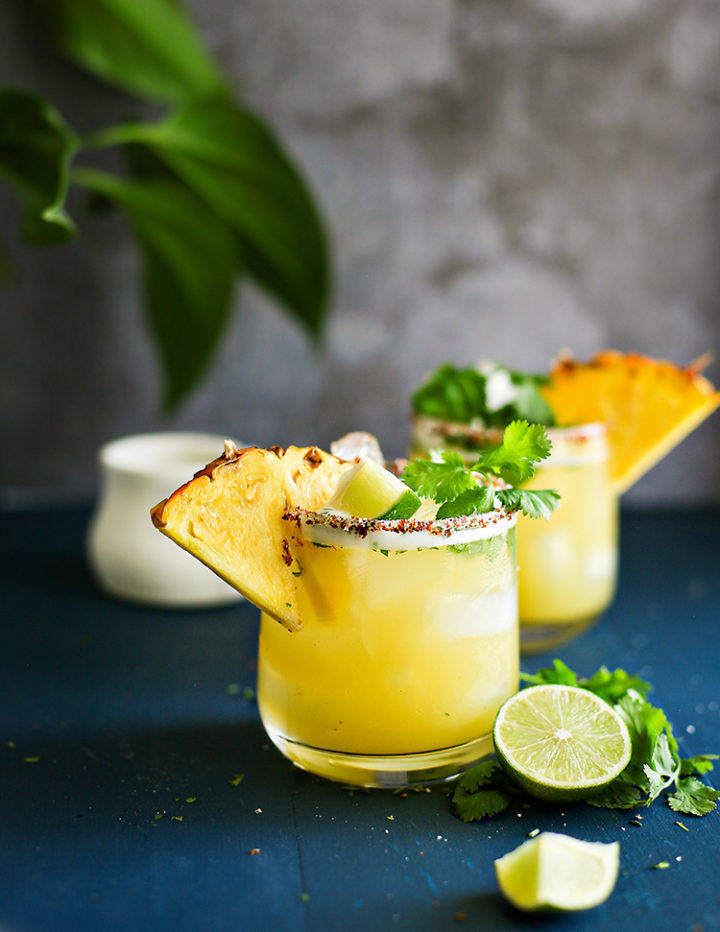 photo of a pineapple margarita with cilantro garnish