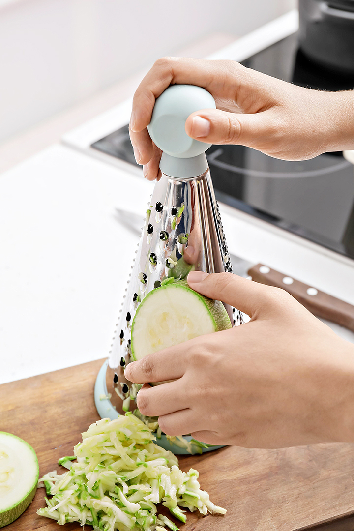 photo of woman grating zucchini for freezing