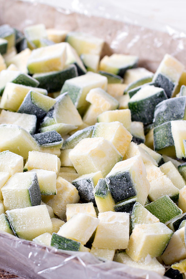 photo of frozen zucchini on a tray for a tutorial on how to freeze zucchini