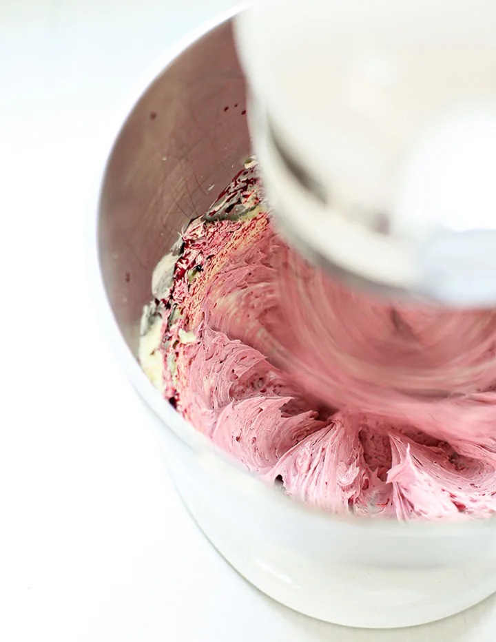 photo of blackberry buttercream being prepared in a mixer for a lemon blackberry cupcake recipe