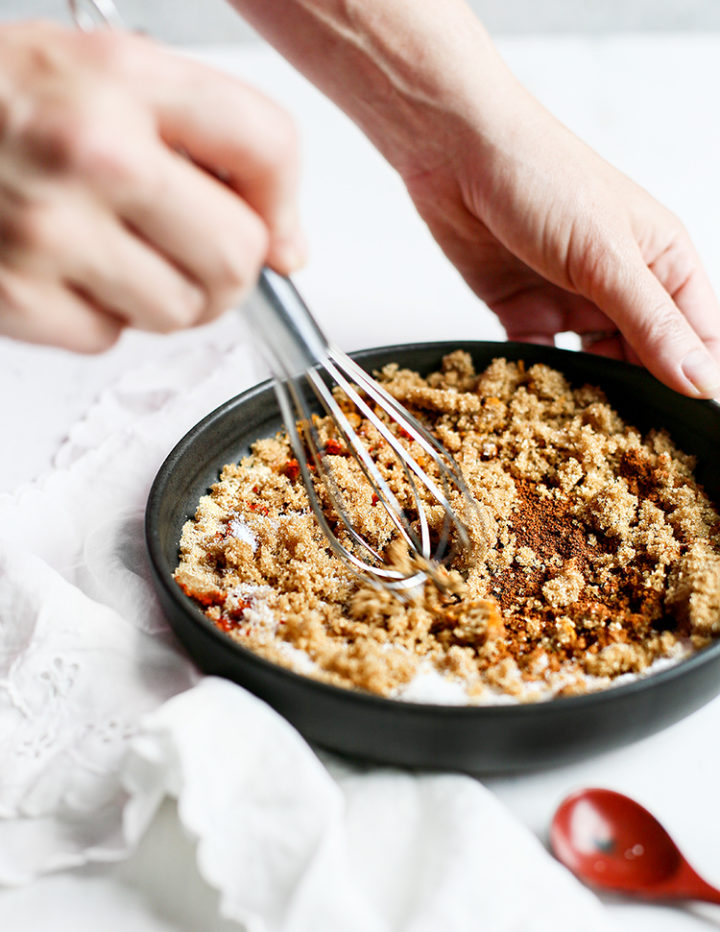 photo of a woman making homemade chicken rub