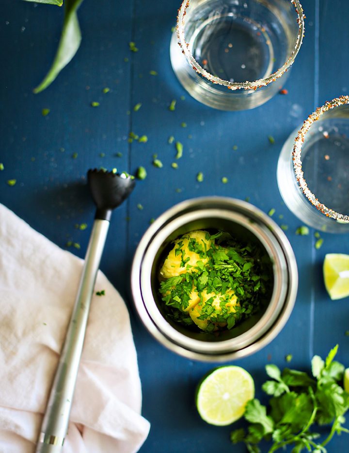 photo of muddling pineapple and cilantro for a pineapple margarita