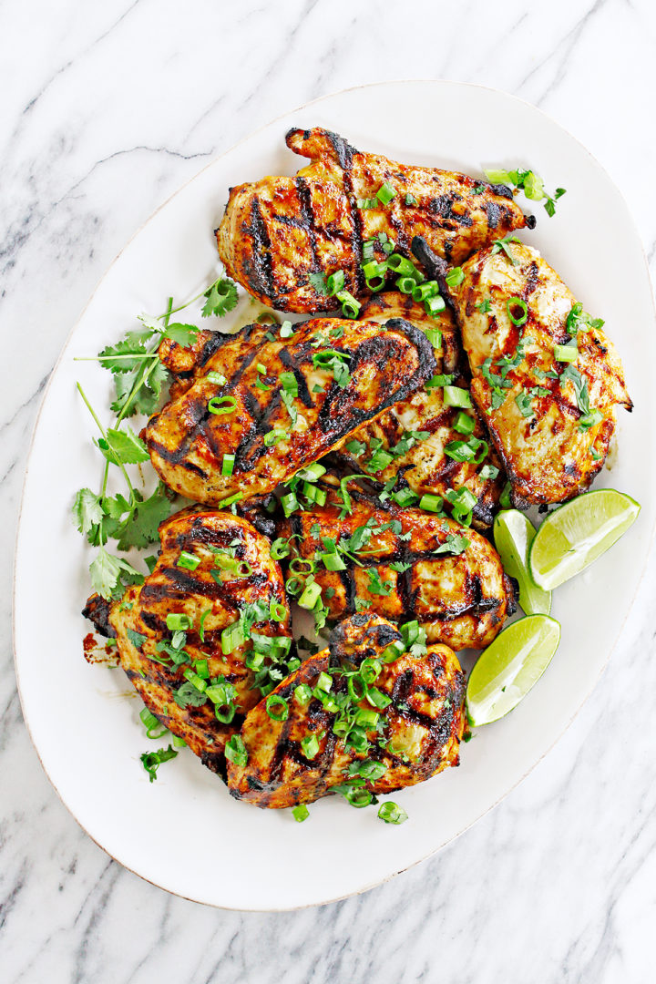 photo of a platter of grilled cilantro lime chicken on a white background for a cilantro lime chicken taco recipe