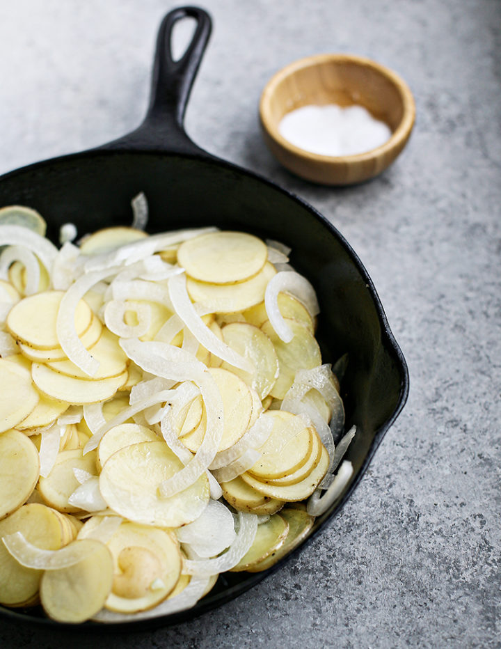 photo of onions and potatoes cooking in a pan for a frittata recipe