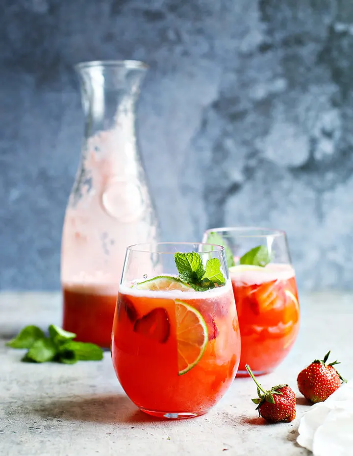 photo of a pitcher of strawberry agua fresca with two glasses