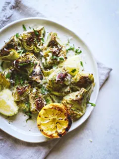 photo of grilled baby artichokes on a plate