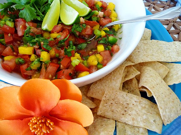 photo of tomato mango salsa in a bowl with tortilla chips