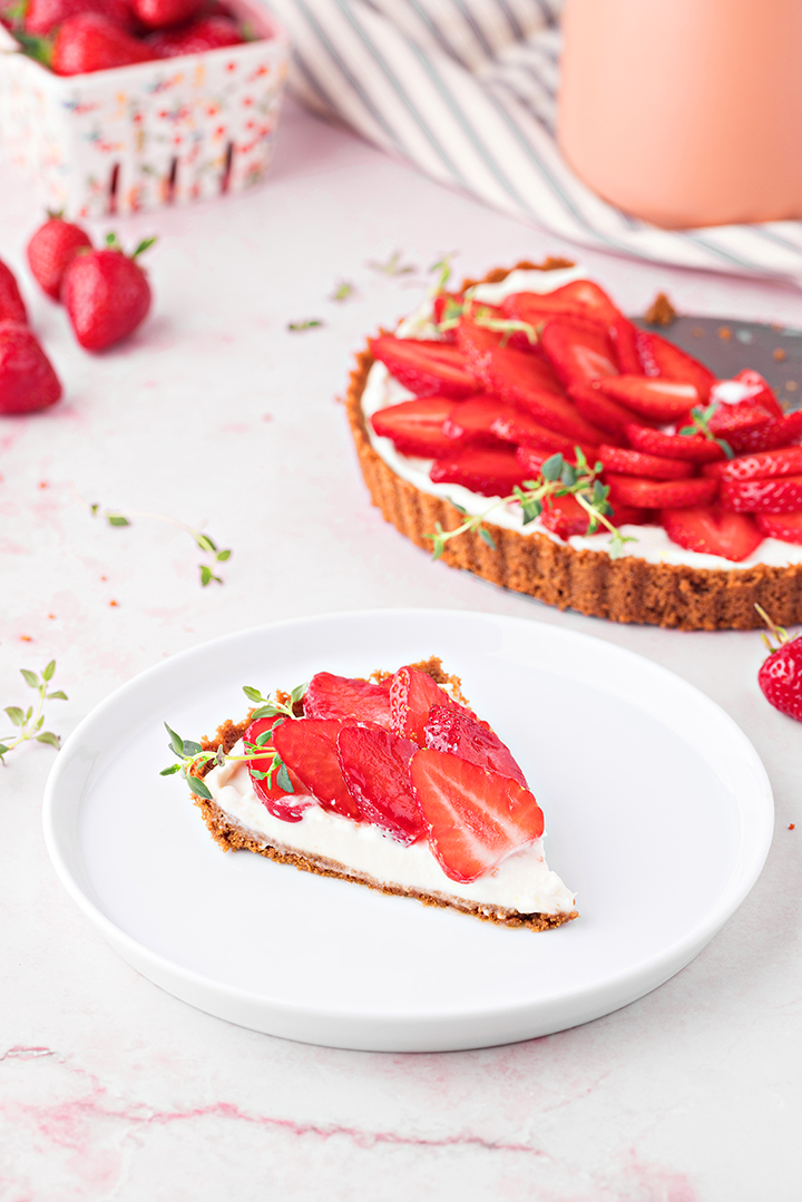 photo of a slice no-bake strawberry lemon tart on a white plate