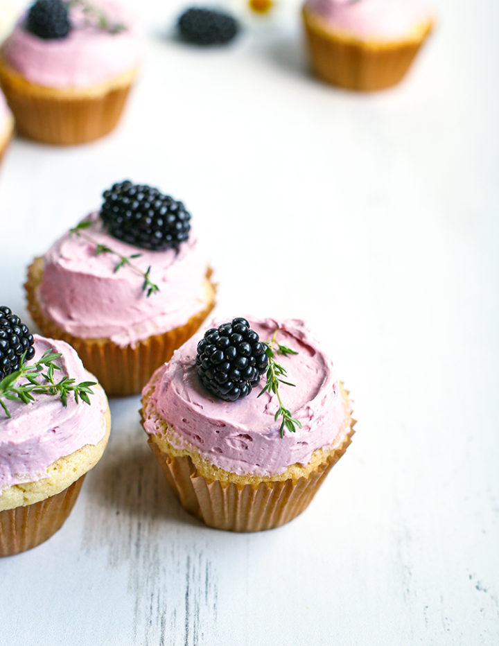 photo of lemon blackberry cupcakes on a white wooden table