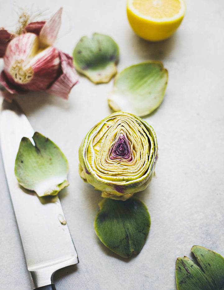 photo of baby artichokes with a knife showing ingredients to make grilled artichokes