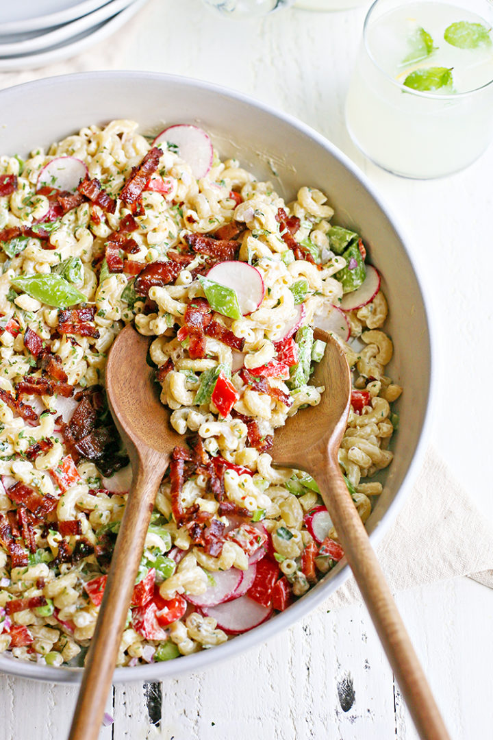 a serving bowl of macaroni salad with bacon on top