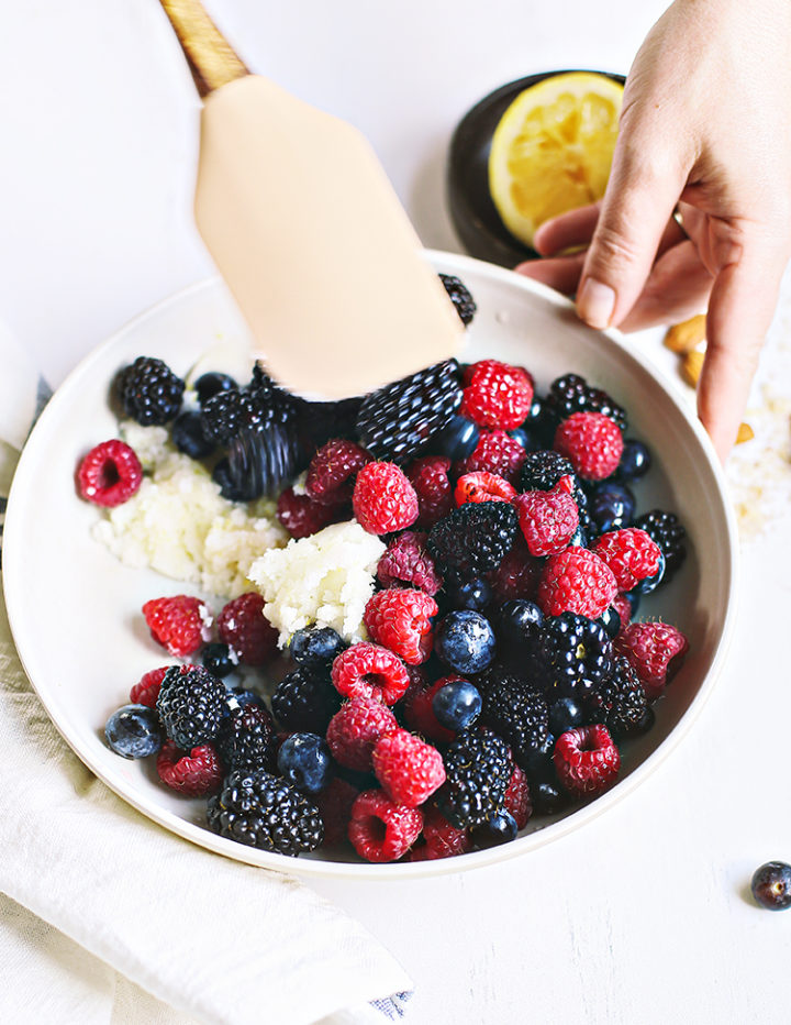 photo of woman preparing the filling for a mixed berry galette