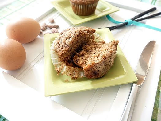 close up photo of a pear muffin cut in half on a small plate