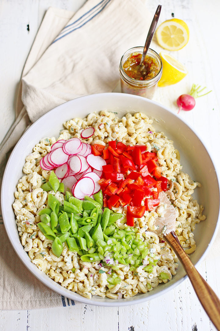 photo of veggies being stirred into the best macaroni salad recipe