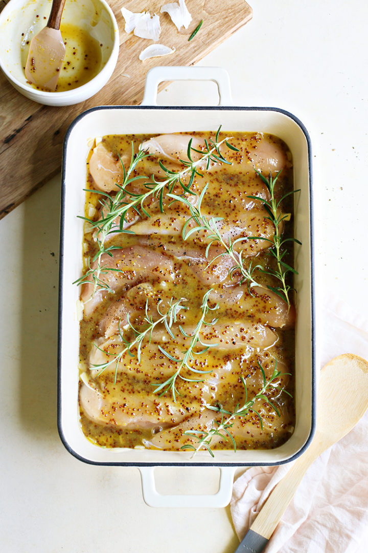photo of chicken tenderloins in a baking dish with honey mustard sauce