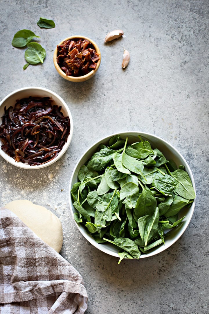 overhead shot of ingredients to make Bacon Pizza with Caramelized Onion