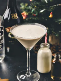 photo of a gingerbread martini in front of a christmas tree
