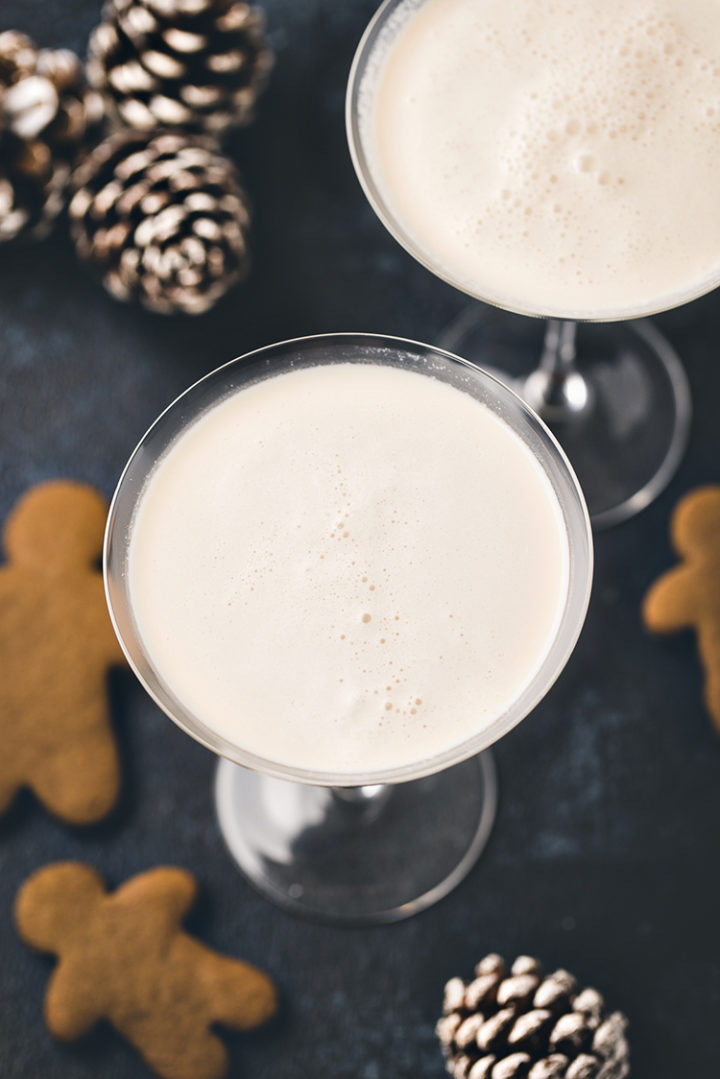 overhead photo of 2 glasses of gingerbread martini with gingerbread cookies for dipping