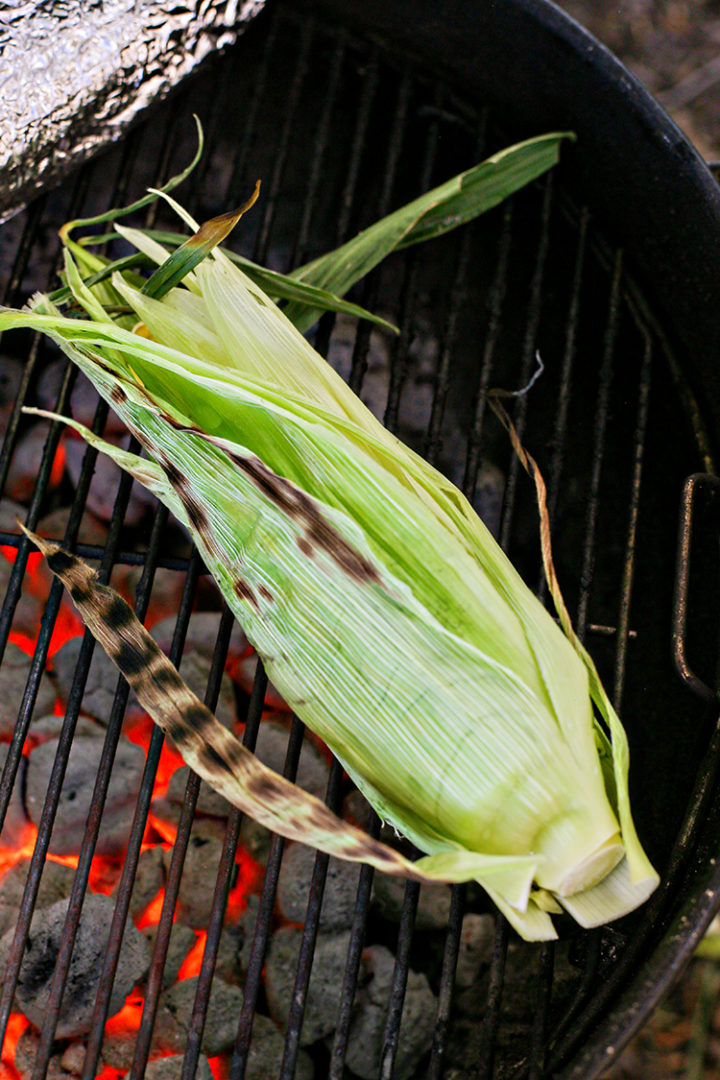 photo of corn being grilled in the husks