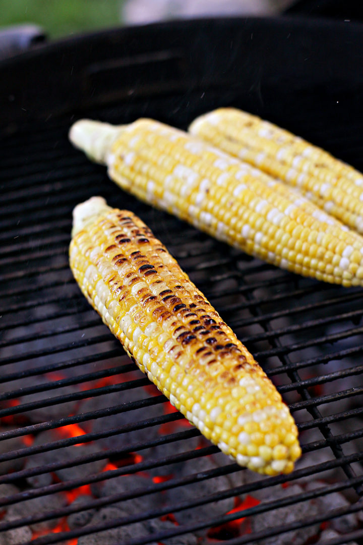 photo of corn being grilled directly on the grill grates