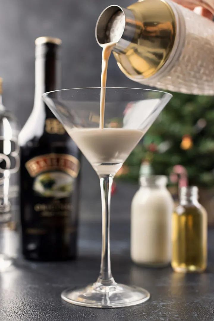 photo of pouring a shaker of a gingerbread martini into a cocktail glass