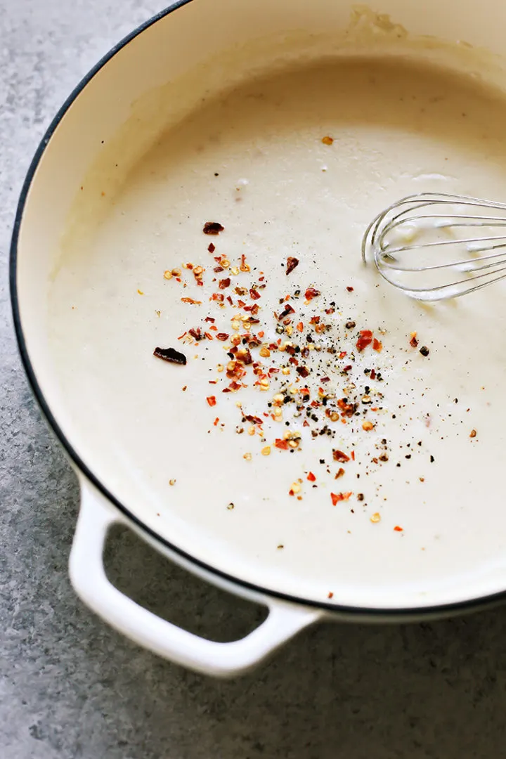 photo of the white pizza sauce for Bacon Pizza with Caramelized Onion