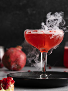 photo of a pomegranate dry ice cocktail for this halloween cocktail recipe