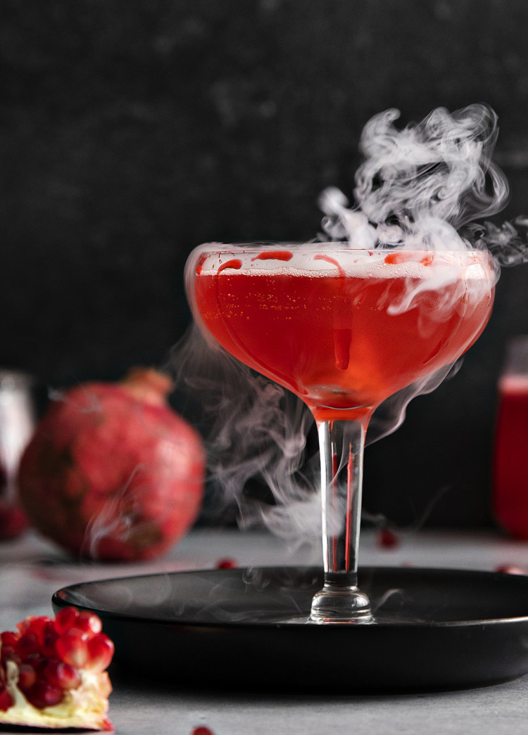 photo of a pomegranate dry ice cocktail for this halloween cocktail recipe