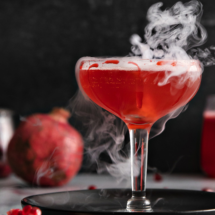 photo of a pomegranate dry ice cocktail for this halloween cocktail recipe