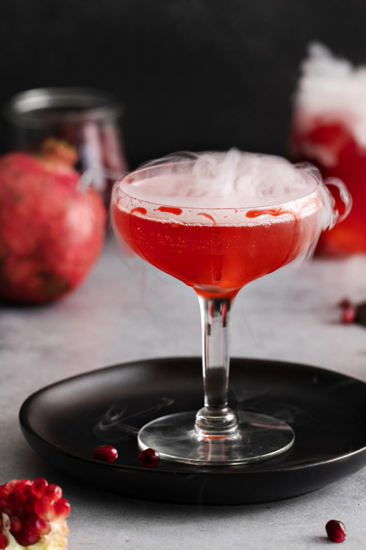 photo of dry ice bubbling in a pomegranate cocktail for halloween