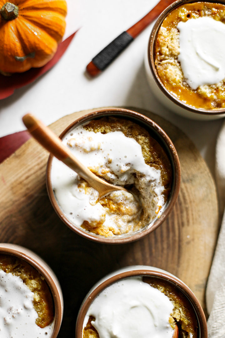 overhead photos of 4 individual  pumpkin cobblers with whipped cream on top