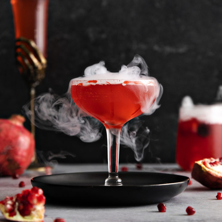 photo of a pomegranate dry ice cocktail for this halloween cocktail recipe