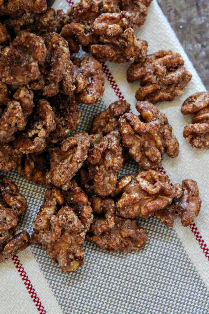 overhead photo of glazed walnuts on a tea towel