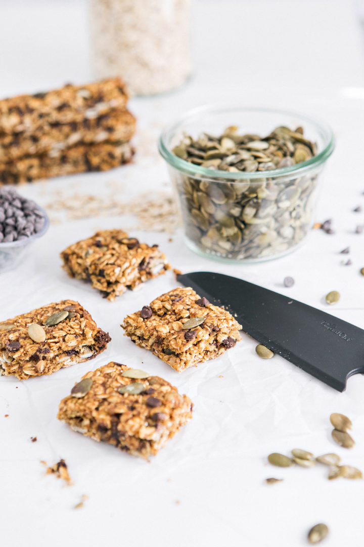 photo of pumpkin chocolate chip granola bars being cut with a knife