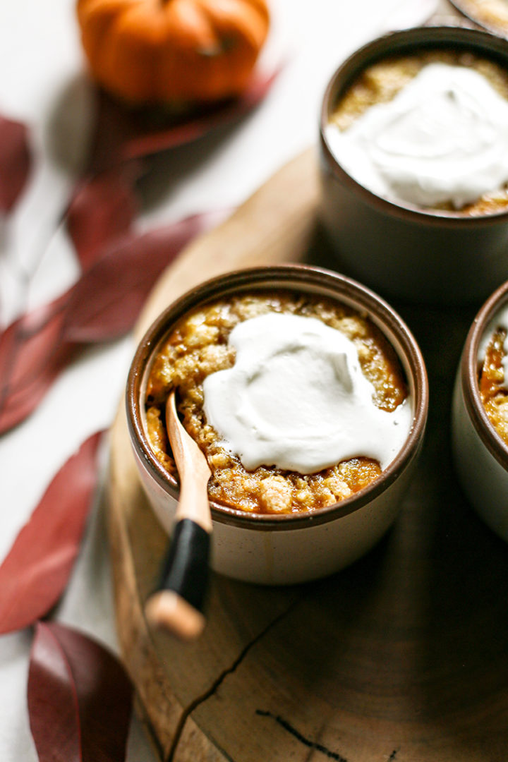 photo of pumpkin cobbler in ramekins with whipped cream on top
