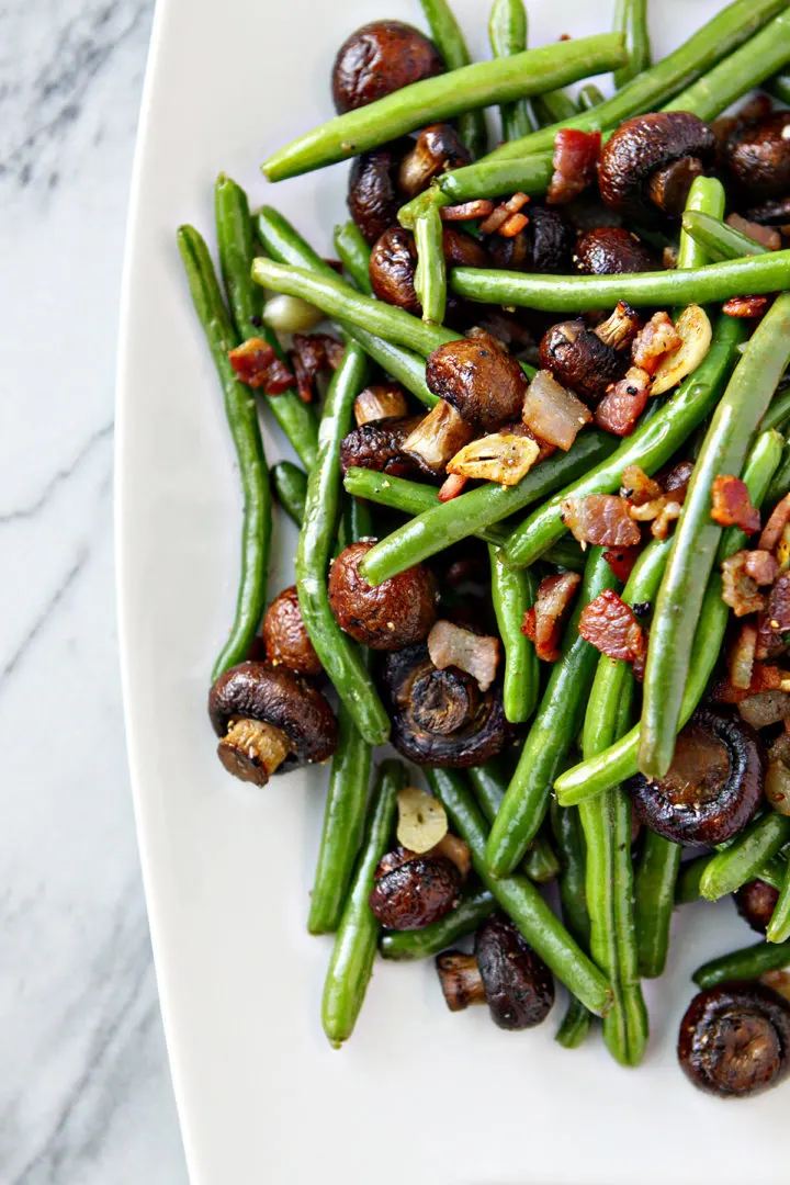 overhead photo of a plate of sautéed green beans and bacon