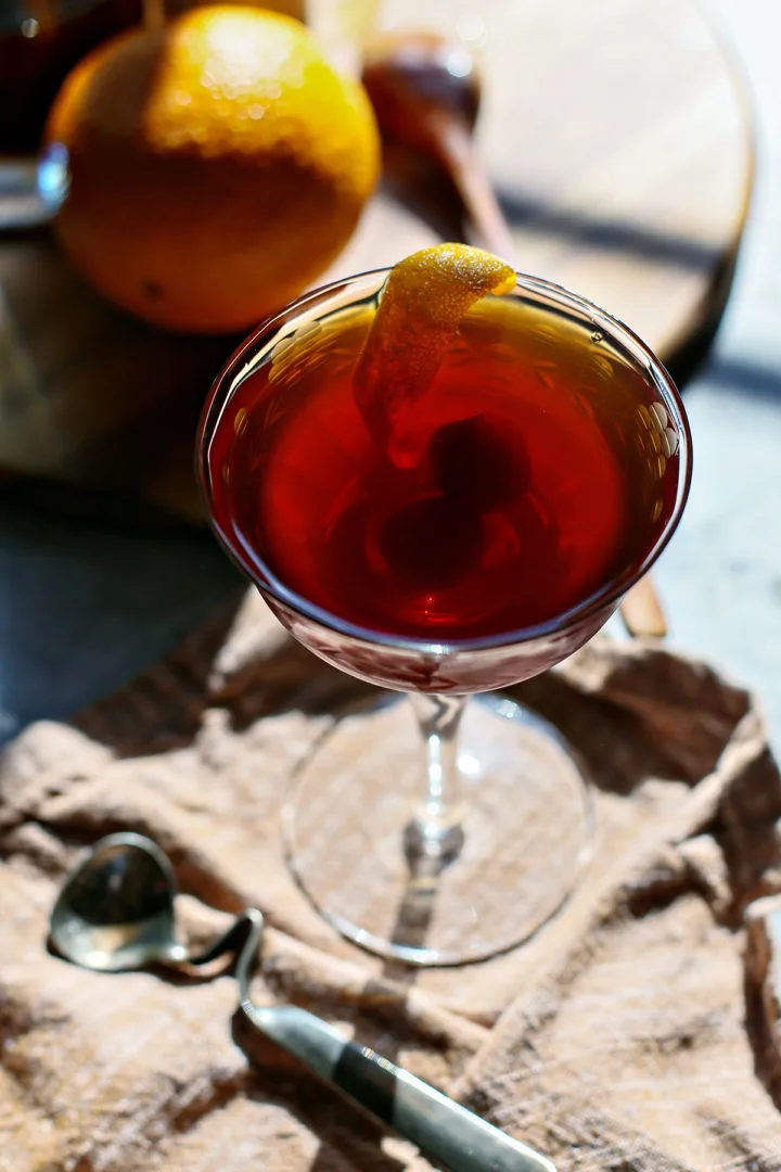 close up photo of the garnishes on a black manhattan