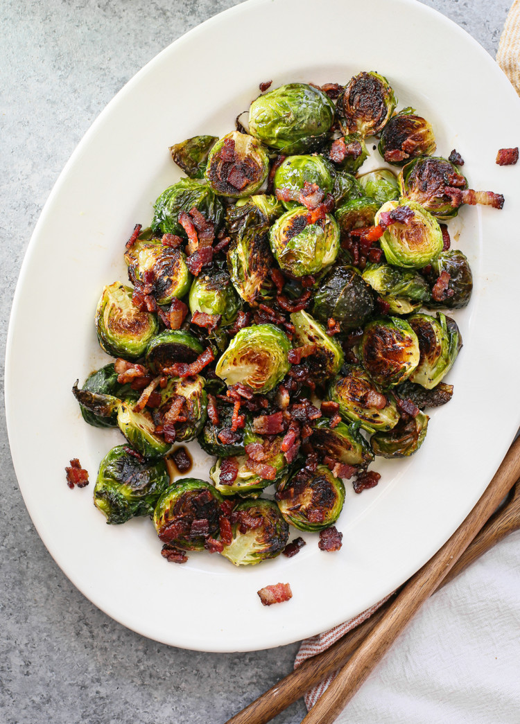 photo of roasted brussel sprouts with bacon on a white serving platter