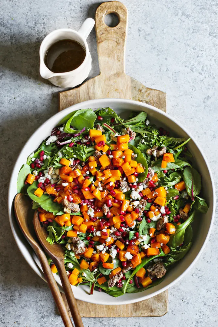salad1 overhead photo of a salad bowl of roasted squash salad on a wooden cutting board