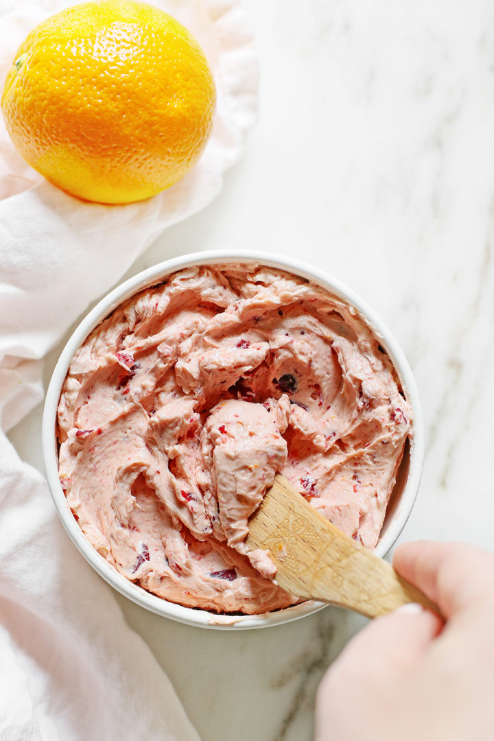 Photo of a woman spreading cranberry butter with a knife