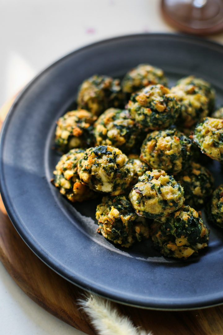 close up photo of spinach balls on a plate