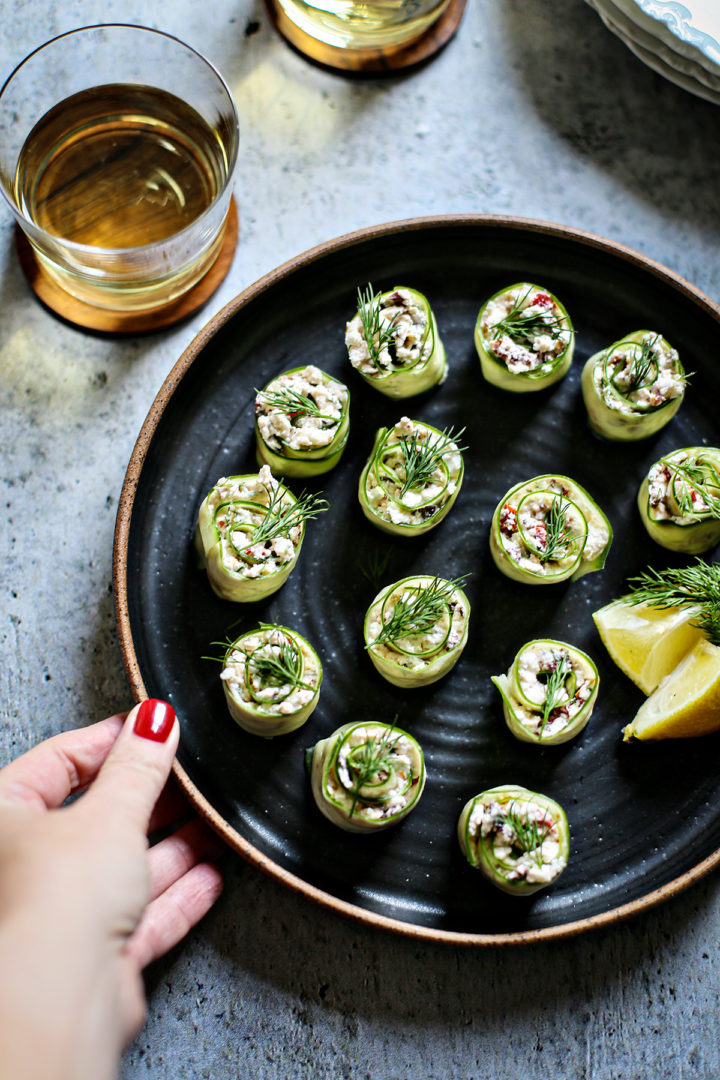 photo of a woman serving a plate of Cucumber Roll Ups